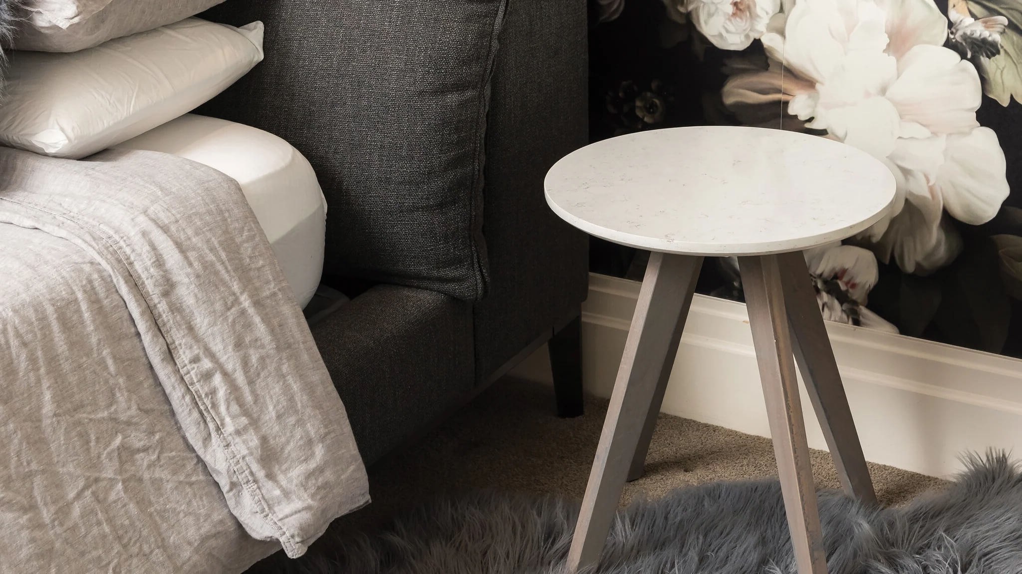 Stone side table beside a bed